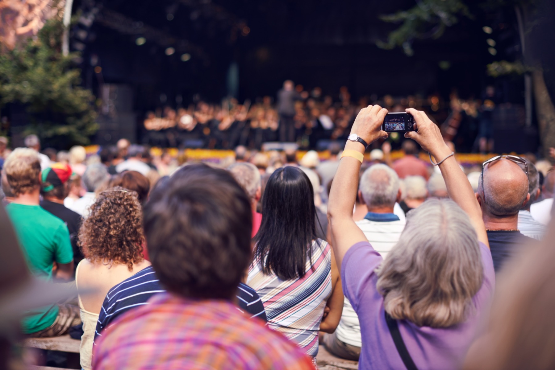 shot-of-a-person-in-the-crowd-holding-a-camera-to-2023-11-27-05-33-04-utc